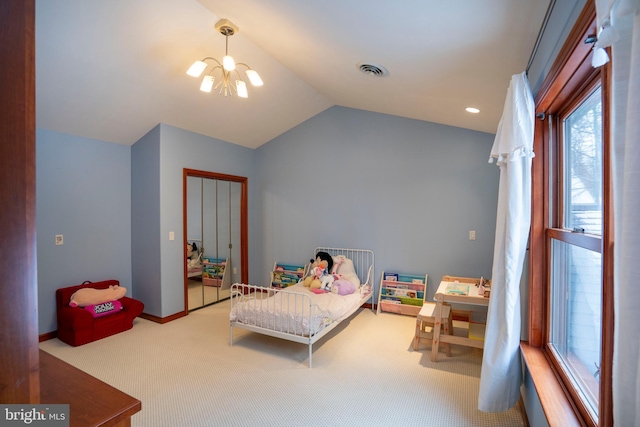 carpeted bedroom with a closet, lofted ceiling, and a notable chandelier