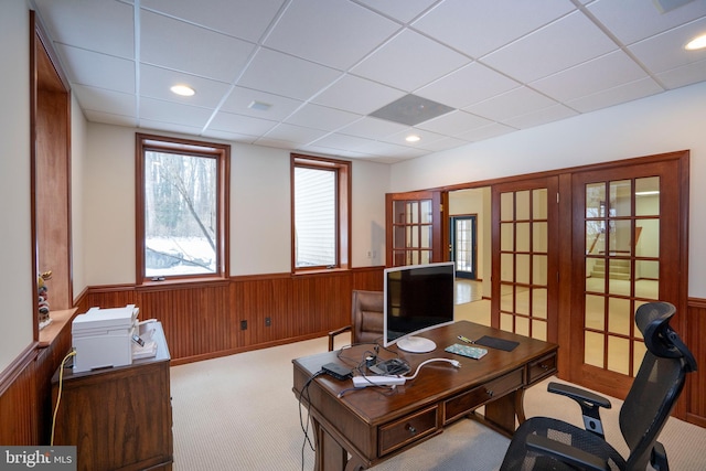 office space with light colored carpet, a drop ceiling, and french doors