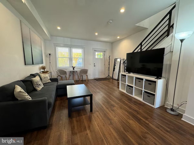 living room featuring dark wood-type flooring, recessed lighting, and baseboards