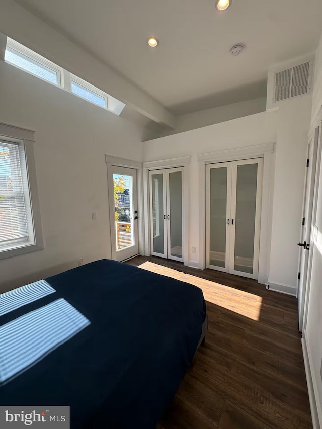 bedroom featuring dark wood-type flooring, recessed lighting, french doors, and visible vents