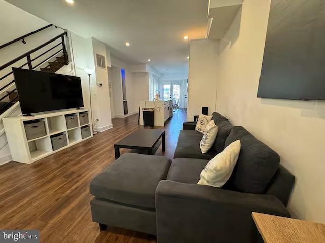 living room featuring baseboards, visible vents, stairway, dark wood-style flooring, and recessed lighting