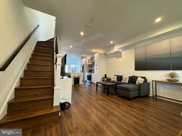 stairway featuring recessed lighting and wood finished floors