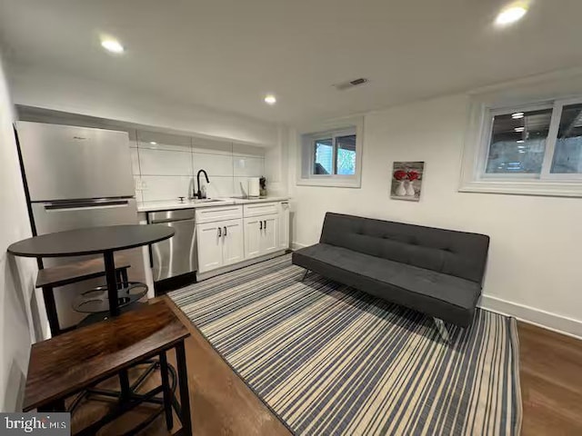 interior space with baseboards, dark wood finished floors, visible vents, and recessed lighting