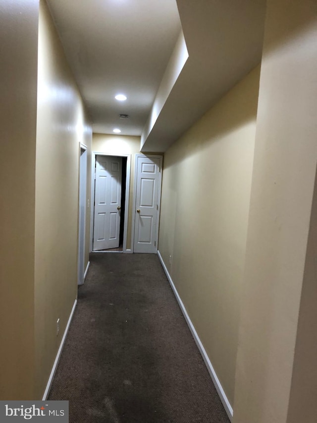 hall with dark carpet