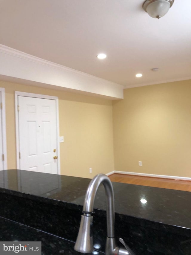 kitchen with hardwood / wood-style flooring and crown molding