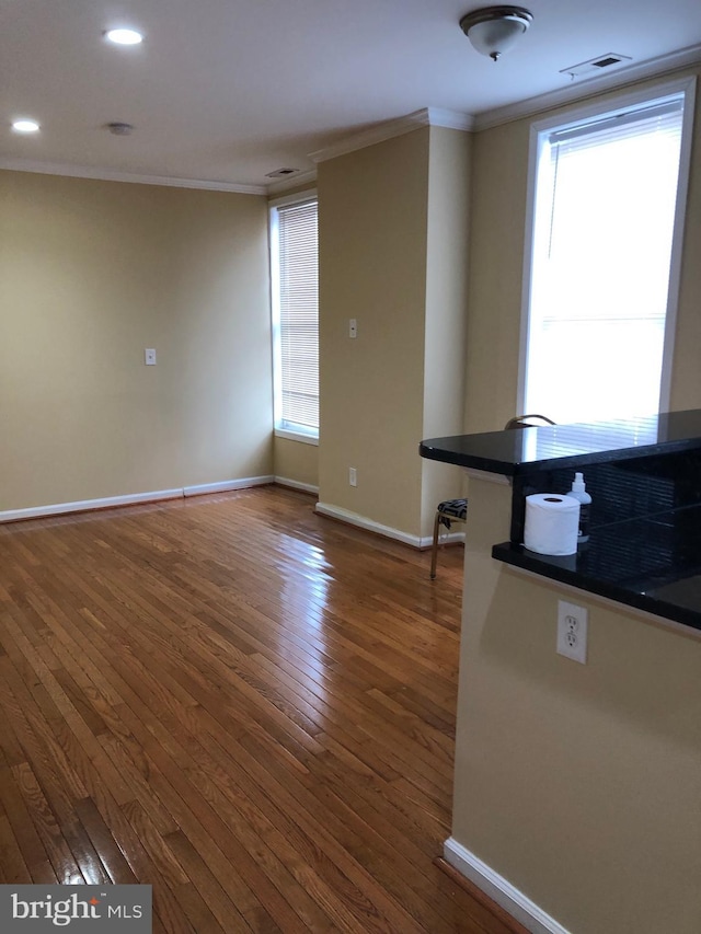 interior space featuring crown molding and dark hardwood / wood-style floors