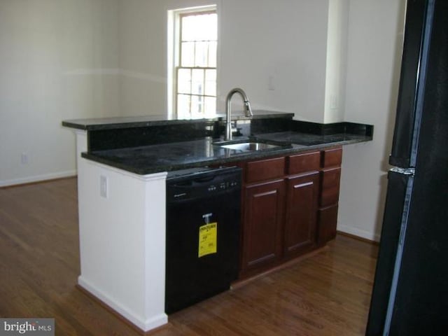 kitchen with dark hardwood / wood-style floors, kitchen peninsula, sink, and black appliances