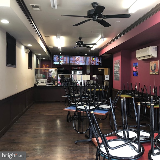 bar featuring hardwood / wood-style flooring and a wall unit AC