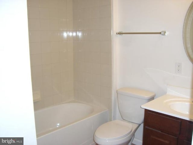 full bathroom featuring vanity, tiled shower / bath combo, and toilet