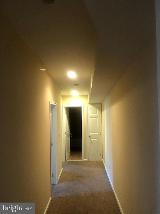 hallway featuring light carpet