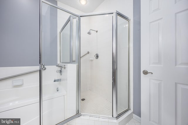 bathroom with plus walk in shower, tile patterned floors, and a textured ceiling