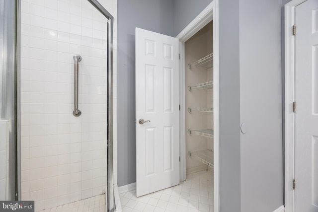 bathroom with a shower with door