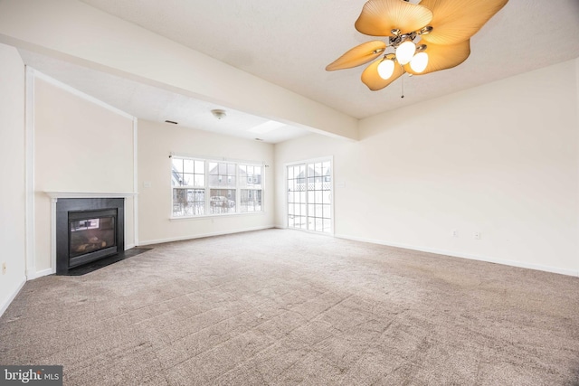 unfurnished living room with beam ceiling, carpet floors, and ceiling fan