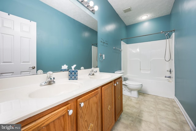 full bathroom featuring vanity, toilet, tub / shower combination, and a textured ceiling