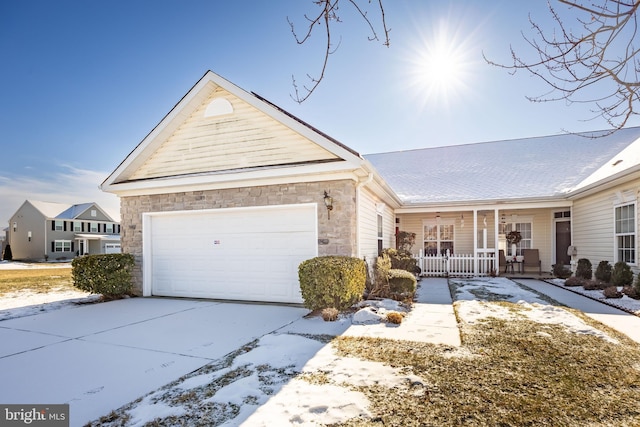 ranch-style house featuring a garage and covered porch