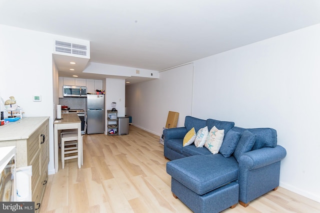 living room with light hardwood / wood-style flooring