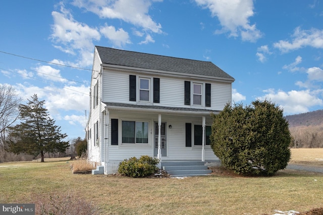 view of front of house with a front yard and a porch