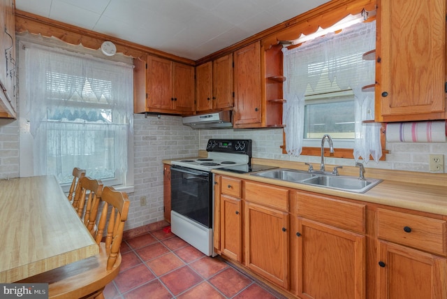 kitchen featuring light tile patterned floors, white electric range oven, and sink