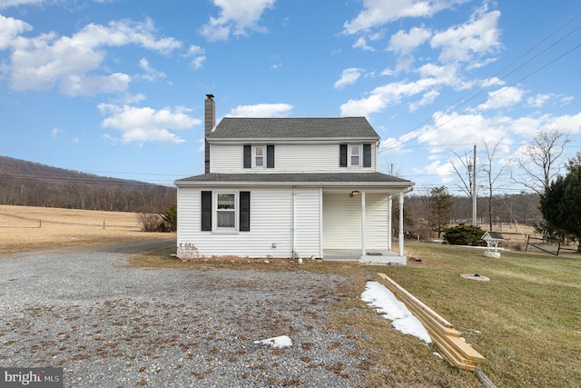 view of property featuring a front yard and covered porch