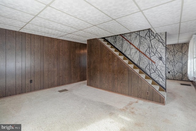 basement with light colored carpet and wooden walls