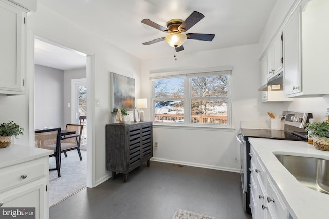 kitchen with white cabinetry, sink, stainless steel electric range, and ceiling fan