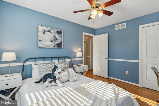 bedroom with ceiling fan and wood-type flooring