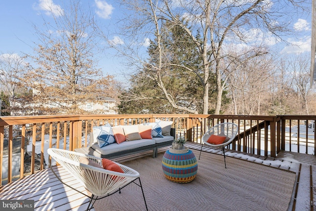 snow covered deck featuring an outdoor living space