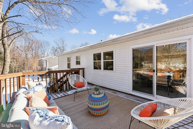 snow covered deck with an outdoor living space