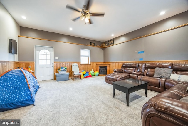 carpeted living room with ceiling fan