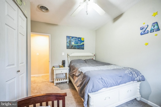 bedroom with ceiling fan, a closet, and carpet flooring