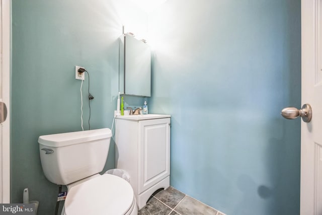 bathroom featuring tile patterned floors, toilet, and vanity