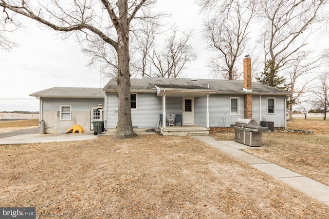 rear view of house with central AC and a patio area