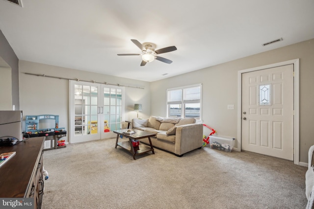 living room with light carpet, ceiling fan, and french doors