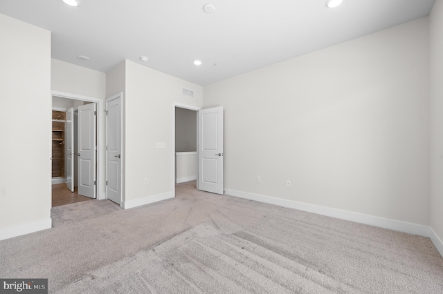 unfurnished bedroom with light colored carpet