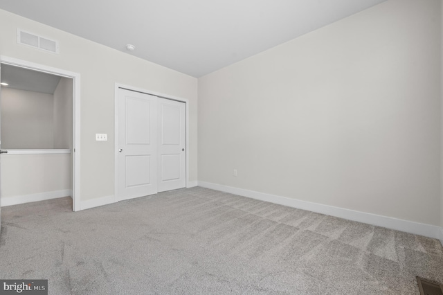 unfurnished bedroom with carpet and a closet