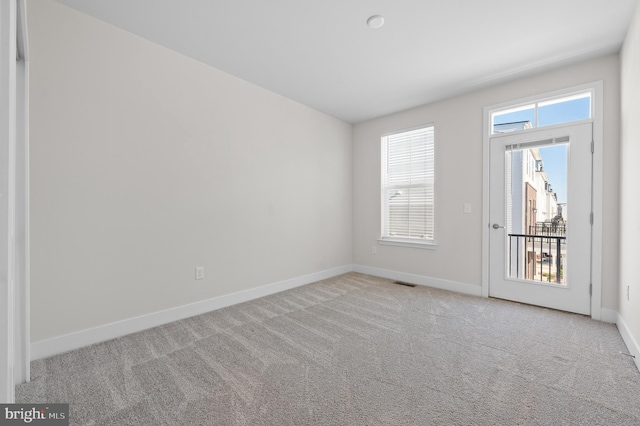 unfurnished room with light colored carpet