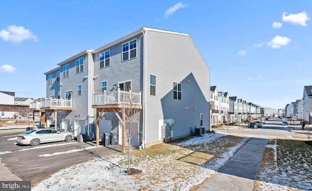 exterior space with a garage and cooling unit