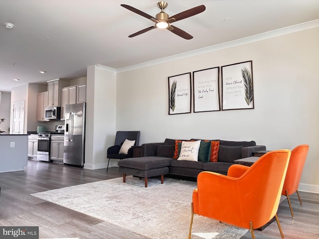 living room with ceiling fan, dark hardwood / wood-style floors, and ornamental molding