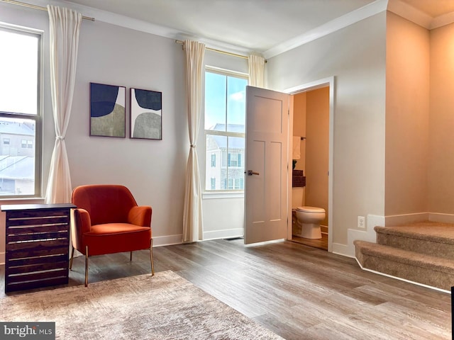 sitting room featuring ornamental molding and hardwood / wood-style floors