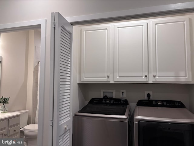 laundry area with cabinets and separate washer and dryer