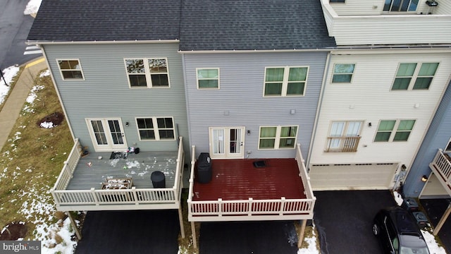 rear view of property with a garage