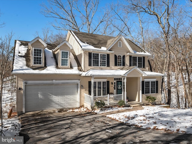 view of front of house featuring a garage and a porch