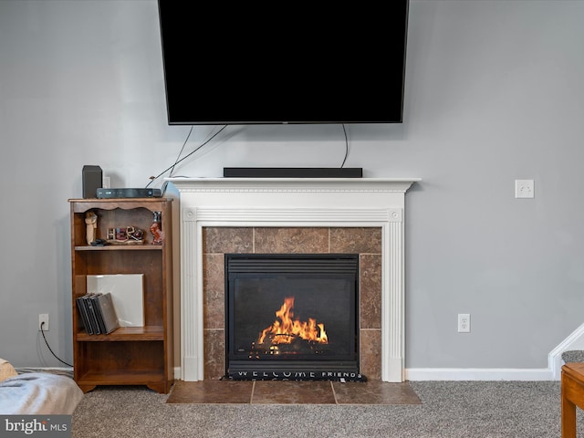 interior details with carpet floors and a fireplace