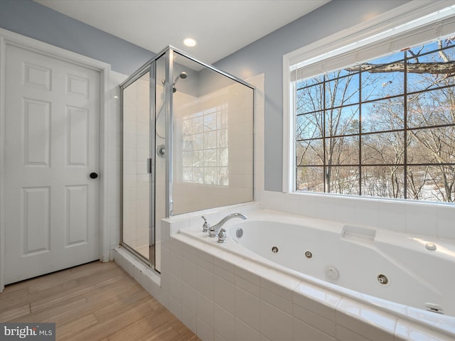 bathroom featuring shower with separate bathtub, a healthy amount of sunlight, and hardwood / wood-style floors