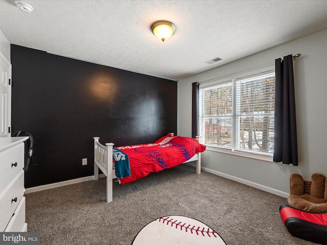 carpeted bedroom featuring a textured ceiling