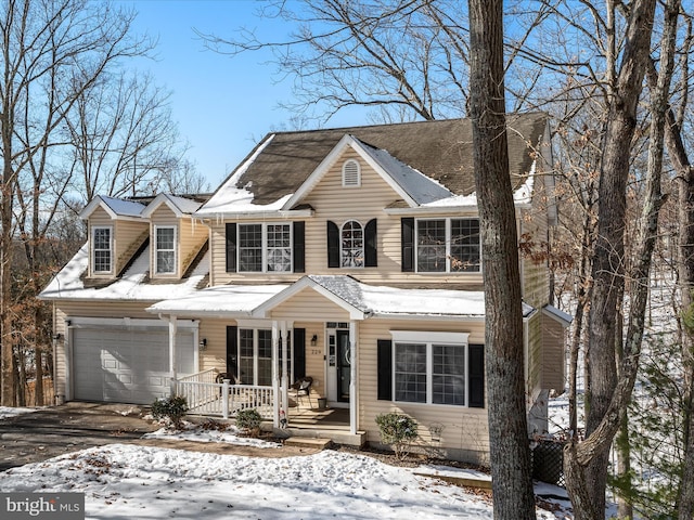 view of front of house featuring a garage and a porch