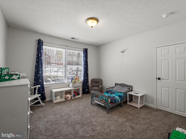 carpeted bedroom featuring a textured ceiling