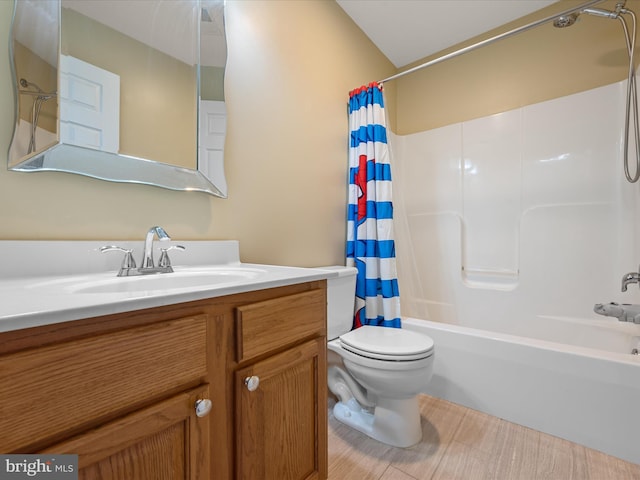 full bathroom with vanity, shower / tub combo, and toilet