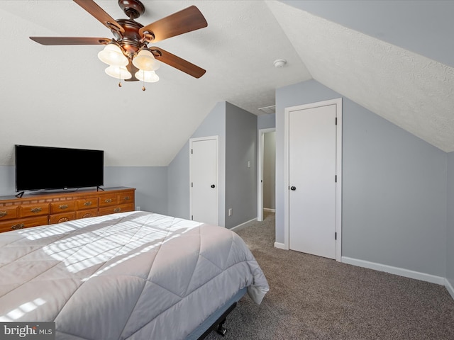 carpeted bedroom with ceiling fan, lofted ceiling, and a textured ceiling