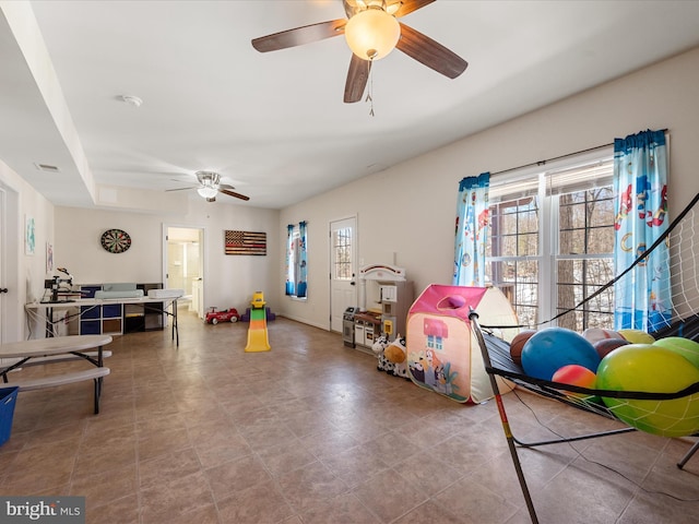 playroom with plenty of natural light and ceiling fan